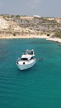 Drone shot of a white yact sailing off the coast of Turkey.