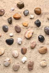 Fototapeta na wymiar Many pebble stones on sand