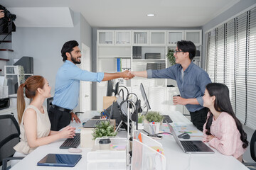 Obraz premium Meeting, partnership and business people shaking hands in the office for a deal, collaboration or onboarding. Diversity, professional and employees with handshake for agreement, welcome or greeting.