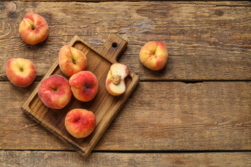 Fototapeta na wymiar Board with sweet fig peaches on wooden background