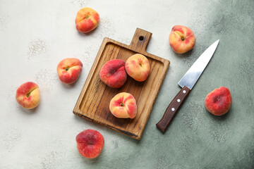 Wooden board with sweet fig peaches on grunge background