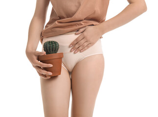Young woman with cactus suffering from cystitis on white background, closeup
