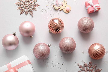 Christmas balls, snowflakes and gift boxes on lilac background