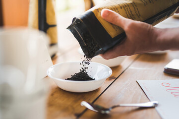 Pouring loose leaf tea into a bowl