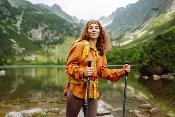 Travel Slovakia, Europe. Tourist with a yellow backpack stands against the backdrop of an alpine...