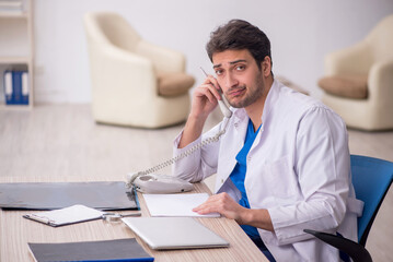 Young male doctor in telemedicine concept