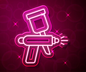 Glowing neon line Paint spray gun icon isolated on red background. Vector