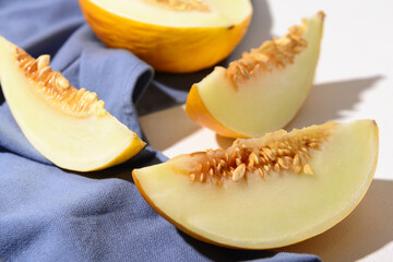 Pieces of sweet melon on white background