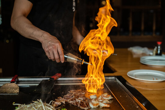 Chef cooking in Japanese teppanyaki restaurant