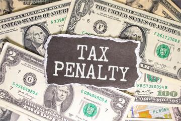 TAX PENALTY written on sticky on notebooks