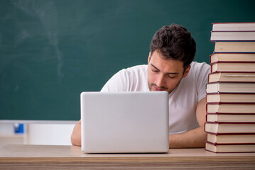 Young male student sitting in the classroom