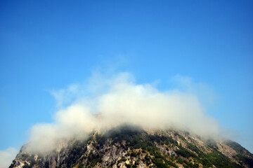 Fog over mountain in the morning. Copy space over nature photography. 