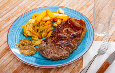 Image of a delicious juicy grilled beef steak and fried potatoes...