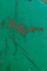 Abstract texture of a metal wall with rusty scuffs. Green color. Closeup