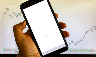 Mock up blank seen on an smartphone over stock chart background in Brazil