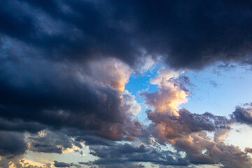 Naklejka na ściany i meble big clouds at sunset before the storm