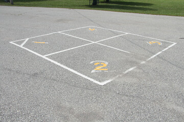 children outdoor four square school yard game printing in white and yellow with one two three four...