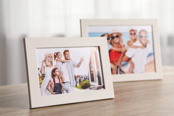 Pleasant memories. Frames with family photos on wooden table indoors, selective focus - Powered by Adobe