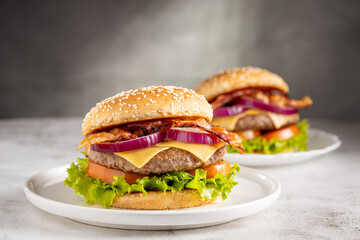 Delicious hamburger with meat, cheese, bacon and salad.