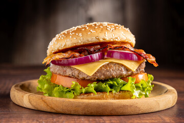 Delicious hamburger with meat, cheese, bacon and salad.