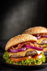 Delicious hamburger with meat, cheese, bacon and salad.
