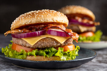 Delicious hamburger with meat, cheese, bacon and salad.