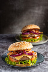 Delicious hamburger with meat, cheese, bacon and salad.