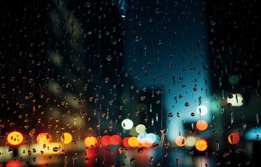  rainy city street evening blurred light Autumn season ,people walk with umbrellas 