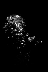 Air bubbles in water on black background
