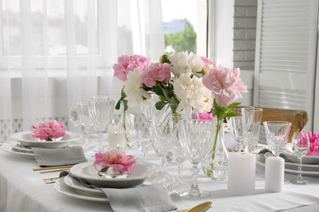 Stylish table setting with beautiful peonies in dining room