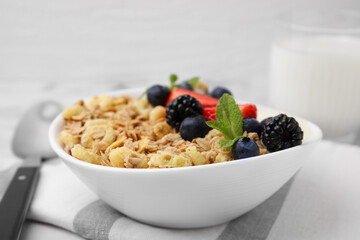 Tasty oatmeal and fresh berries in bowl on table, closeup. Healthy breakfast