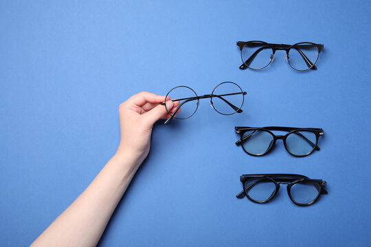 Woman with different stylish glasses on blue background, top view