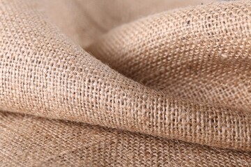 Texture of beige burlap fabric, closeup view