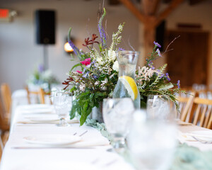 light and airy floral table setting, with whites, tans and greens.