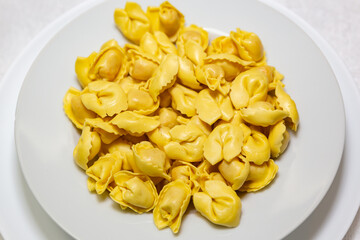 Italian tortellini (capeletti, agnolini) soup with chicken and vegetables, special soup for cold nights