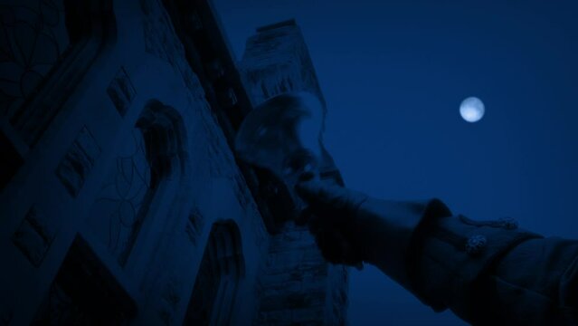 Man Rings Bell Outside Building In The Moonlight