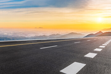 Asphalt highway road and mountain with skyline scenery at sunrise
