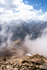 beautiful snowy mountain peaks in the clouds. highlands