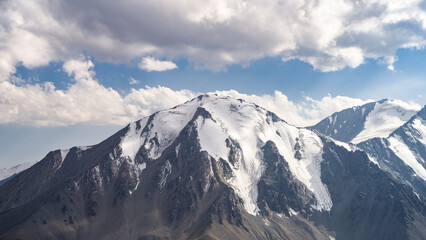 Fototapeta na wymiar beautiful snowy mountain peaks in the clouds. highlands