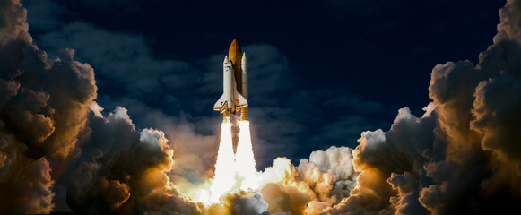 Launch of Space Shuttle Atlantis, Spaceship takes off into the night sky on a mission. Rocket...