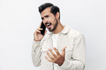 Closeup portrait man talking on the phone angry annoyance and quarrel on white isolated background, fashion style clothes, copy space, space for text