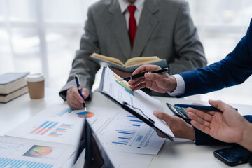 Business people meeting explaining the financial graph data and marketing plan. Businessmen meeting about business project, marketing, presentation and brainstorming for company profit.