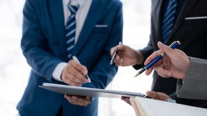 Business people meeting explaining the financial graph data and marketing plan. Businessmen meeting about business project, marketing, presentation and brainstorming for company profit.