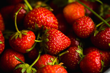 Red ripe strawberry in gray bowl on the rustic background. Selective focus. Shallow depth of field.