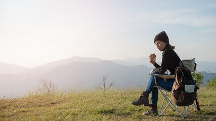 woman traveler drinks coffee with view of mountain landscape. young tourist woman drinks hot drink from cup and enjoyed the scenery in mountains. trekking concept. concept adventure active vacations.
