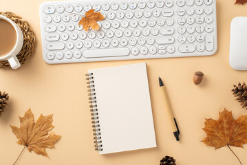 Warm autumn office scene. Top view featuring keyboard, mouse, cup of cocoa, spiral notebook, pen,...