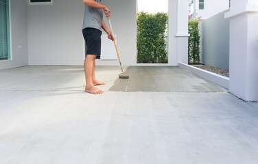 Worker and renovation work. To using roller painting mortar cement or finishing material for repair...