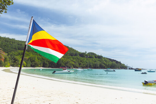 The flag of Seychelles mounted on the beach