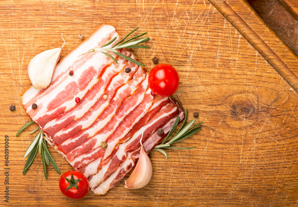 Wall mural Smoked sausage with rosemary and peppercorns tomatoes and garlic