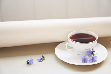 The composition of the drink from chicory, cups and saucers on a wooden table with space for copying. A healthy drink made from chicory. High quality photo